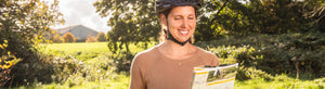 Woman wearing helmet reading Sustrans' regional map