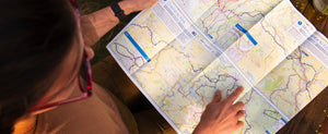 A woman reading one of Sustrans' long distance cycle maps