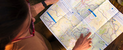 A woman reading one of Sustrans' long distance cycle maps