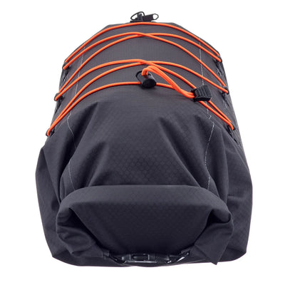 Black dry pack with orange straps for securing items to the bag.